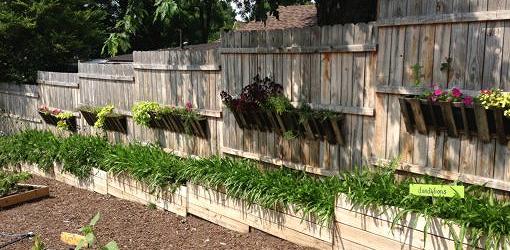 Fence built on sloping ground with planters.