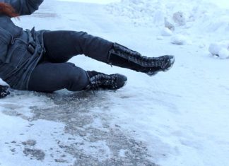 Woman slips on icy driveway during the winter