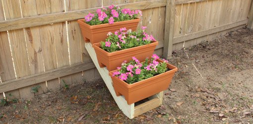 DIY stepped plant container display rack made from stair stringers.