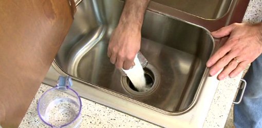 Using baking soda to clean a garbage disposal.