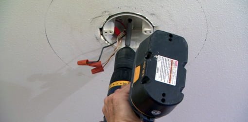 Attaching a ceiling electrical box to a wood support.