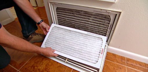 Changing air filter on central heating/cooling unit.