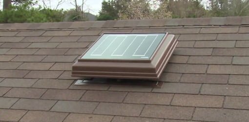 Solar powered attic ventilator mounted on roof.