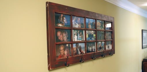 French door photo gallery and coat rack mounted on wall.