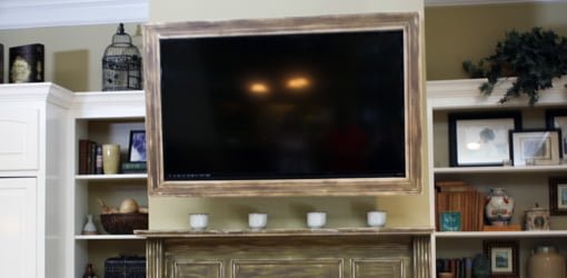 Custom picture frame mounted on TV set.