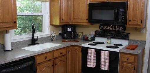 Remodeled kitchen with new solid surface countertops and faucet.
