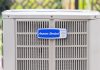 American Standard air conditioner condenser unit, seen outdoors on a bright sunny day