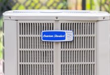 American Standard air conditioner condenser unit, seen outdoors on a bright sunny day