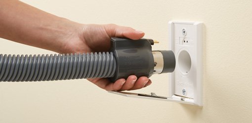 Attaching hose to wall outlet of NuTone central vacuum system.