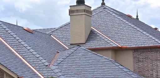 Roof with polymer slate tile roofing.