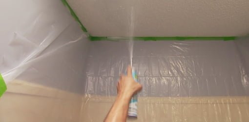 Spraying ceiling with texture in a can.