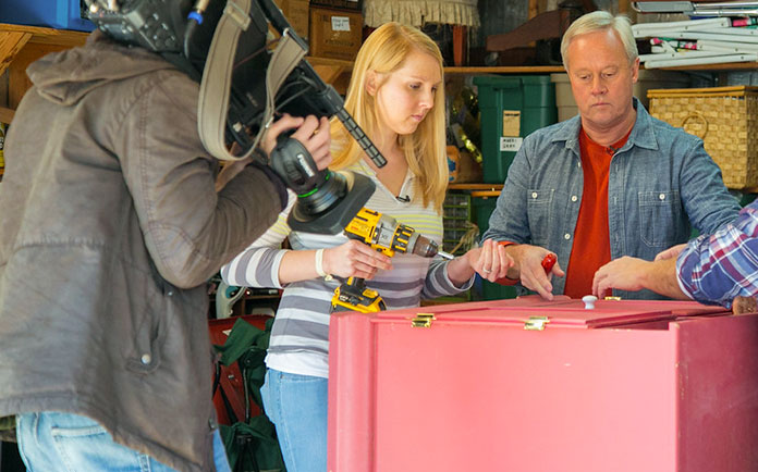 “Today’s Homeowner” hosts Danny Lipford and Chelsea Lipford Wolf remove unnecessary parts from the pink hutch before upcycling it. 