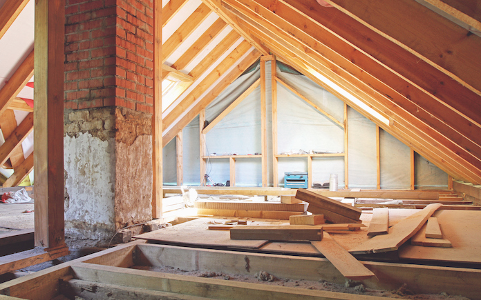 An interior view of a house attic under construction with stone wool insulation