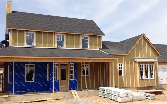 Exterior of new home under construction with stone wool insulation showing