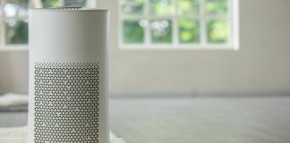 Air purifier in cozy white living room for filter and cleaning removing dust