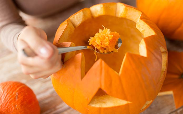 Removing a pumpkin's seeds and pulp to preserve it