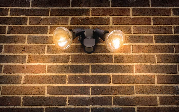 Flood lights flowing from a brick porch