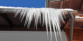 Icicles hanging from the edge of a residential roof