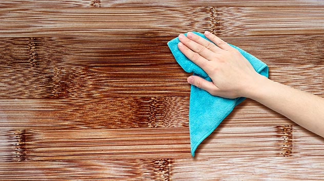Cleaning wooden table with water stains