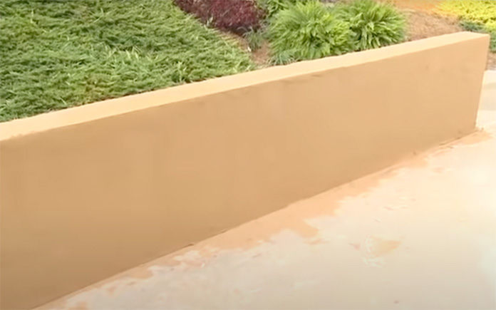 Curing the surface of a concrete block wall with a QuickWall finish