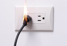 Electrical outlet with a plug on fire