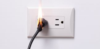 Electrical outlet with a plug on fire