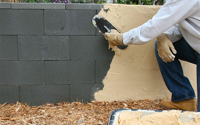 Applying a stucco finish to a concrete block wall