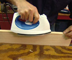 Using an iron to heat glue on veneer for banding plywood edges