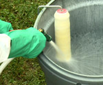 Cleaning a paint roller with a hose
