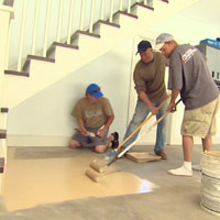 Applying epoxy floor coating to garage floor