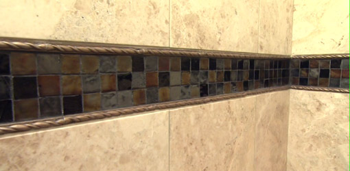 Tub surround tile with mosaic band inlay.