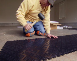 Installing Norsk PVC garage floor tiles.