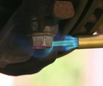 Heating bolt with propane torch.