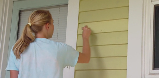 Painting the exterior siding on the house.