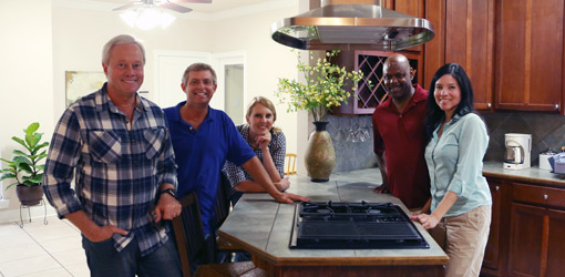 Today's Homeowner crew and contest winners in kitchen by island and new range hood.