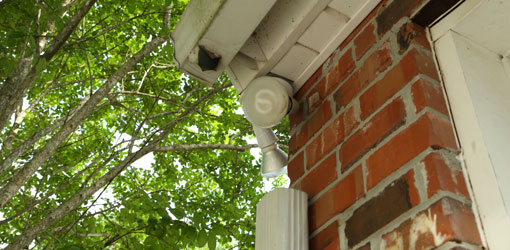 Gutter on brick house with missing downspout elbows.