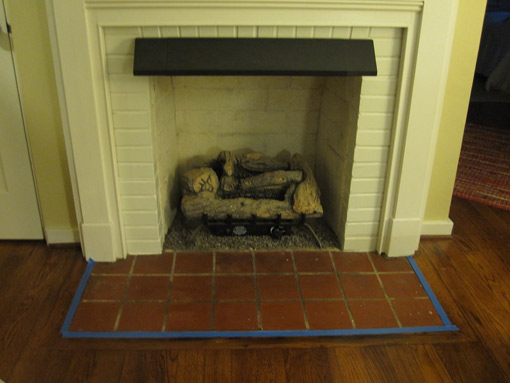 Painter's tape around fireplace hearth.