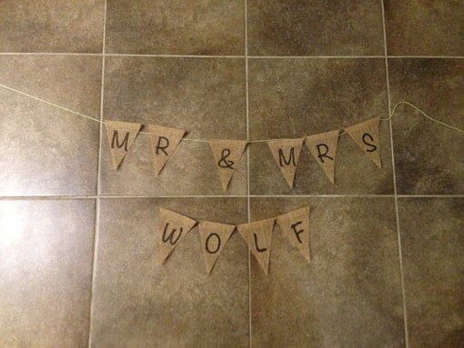 Burlap bunting banner laid on floor with yarn