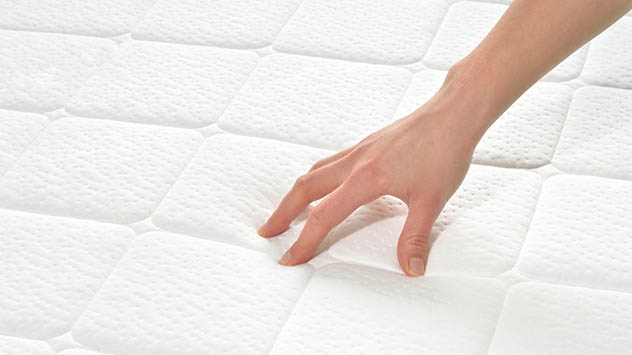 Hand on mattress