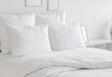 Bed with white sheets and duvet cover