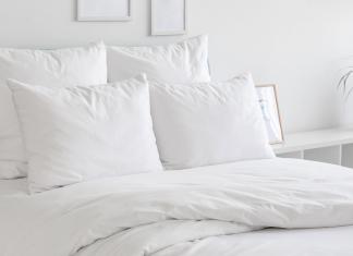 Bed with white sheets and duvet cover