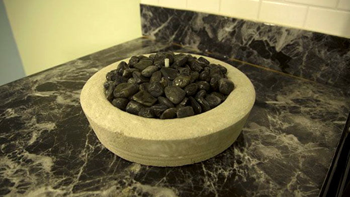 Concrete fire bowl with polished stones from the dollar store inside