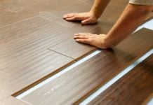 Man installing laminate plank flooring