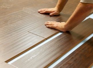 Man installing laminate plank flooring