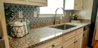 Granite countertops in a kitchen with a window overlooking the sink
