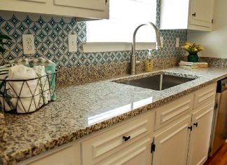 Granite countertops in a kitchen with a window overlooking the sink