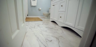 White bathroom with ceramic tile that looks like marble