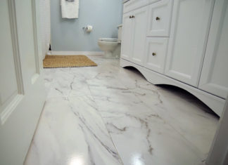 White bathroom with ceramic tile that looks like marble