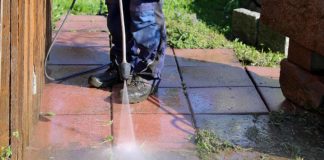 Man cleans a paver patio with a rental pressure washer