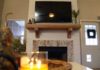 Faux shiplap fireplace with mantel and candle on accent table